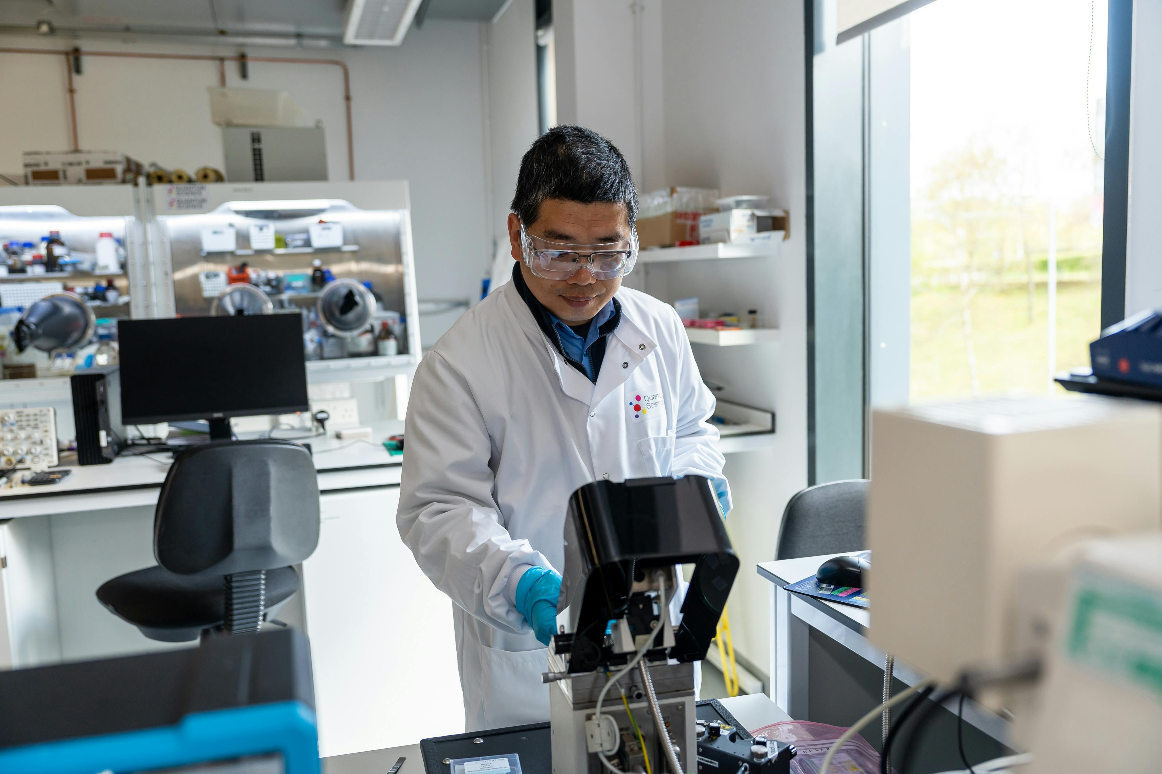 A scientist operating an atomic force microscope (AFM) used to measure properties of quantum dot films.