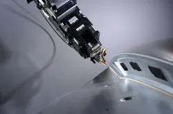 FIGURE 1. Adaptive laser optics follow the 3D contour. Its camera sends live images to a neural network, which detects defects from a laser brazing process in real time. FIGURE 1. Adaptive laser optics follow the 3D contour. Its camera sends live images to a neural network, which detects defects from a laser brazing process in real time.