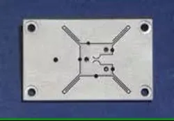 FIGURE 1. A high-speed, high-precision rotational stage is formed from a single piece of aluminum. The rotational platform (center) is attached to the outer frame by flexure hinges that are formed by electric-discharge machining. FIGURE 1. A high-speed, high-precision rotational stage is formed from a single piece of aluminum. The rotational platform (center) is attached to the outer frame by flexure hinges that are formed by electric-discharge machining.
