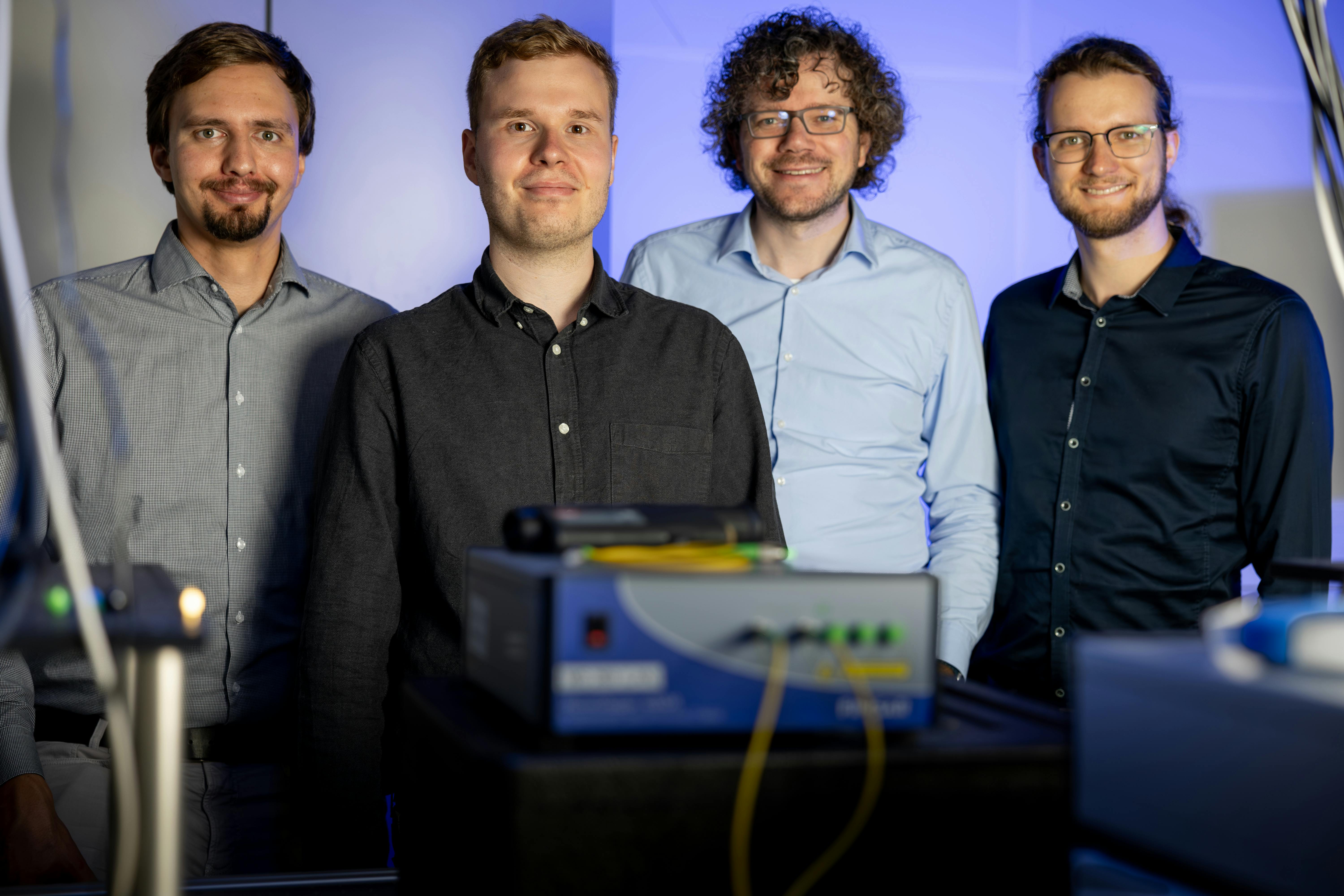 The team in the quantum optics lab: (left to right) Jan Heine, Philip R&uuml;beling, Michael Kues, and Robert Johanning.