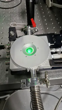 Close-up of the solar cell under cryogenic conditions being powered by a laser. Close-up of the solar cell under cryogenic conditions being powered by a laser.