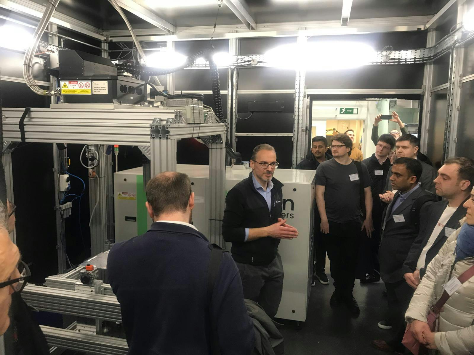 Attendees observe a hands-on demonstration of Civan Lasers&rsquo; OPA6 dynamic beam laser, showcasing real-time beam shaping capabilities for industrial applications.