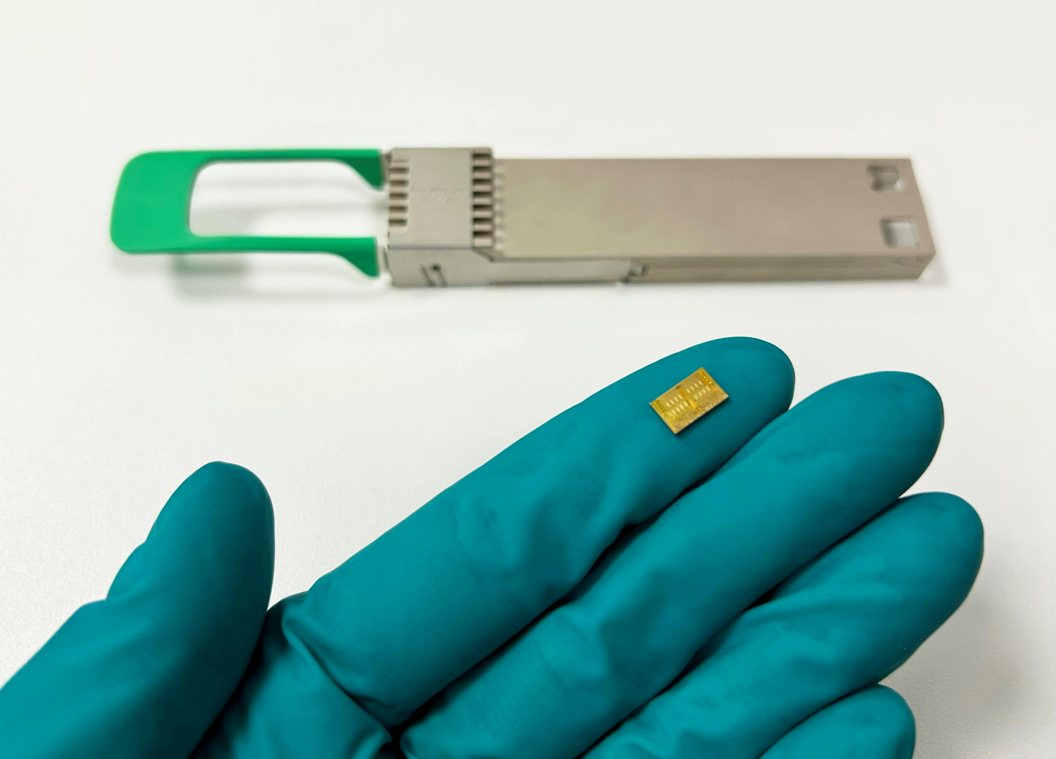 On the glove: A SCINTIL chip&mdash;a bank of 16 lasers monolithically integrated on a silicon photonic circuit and wavelength multiplexed.