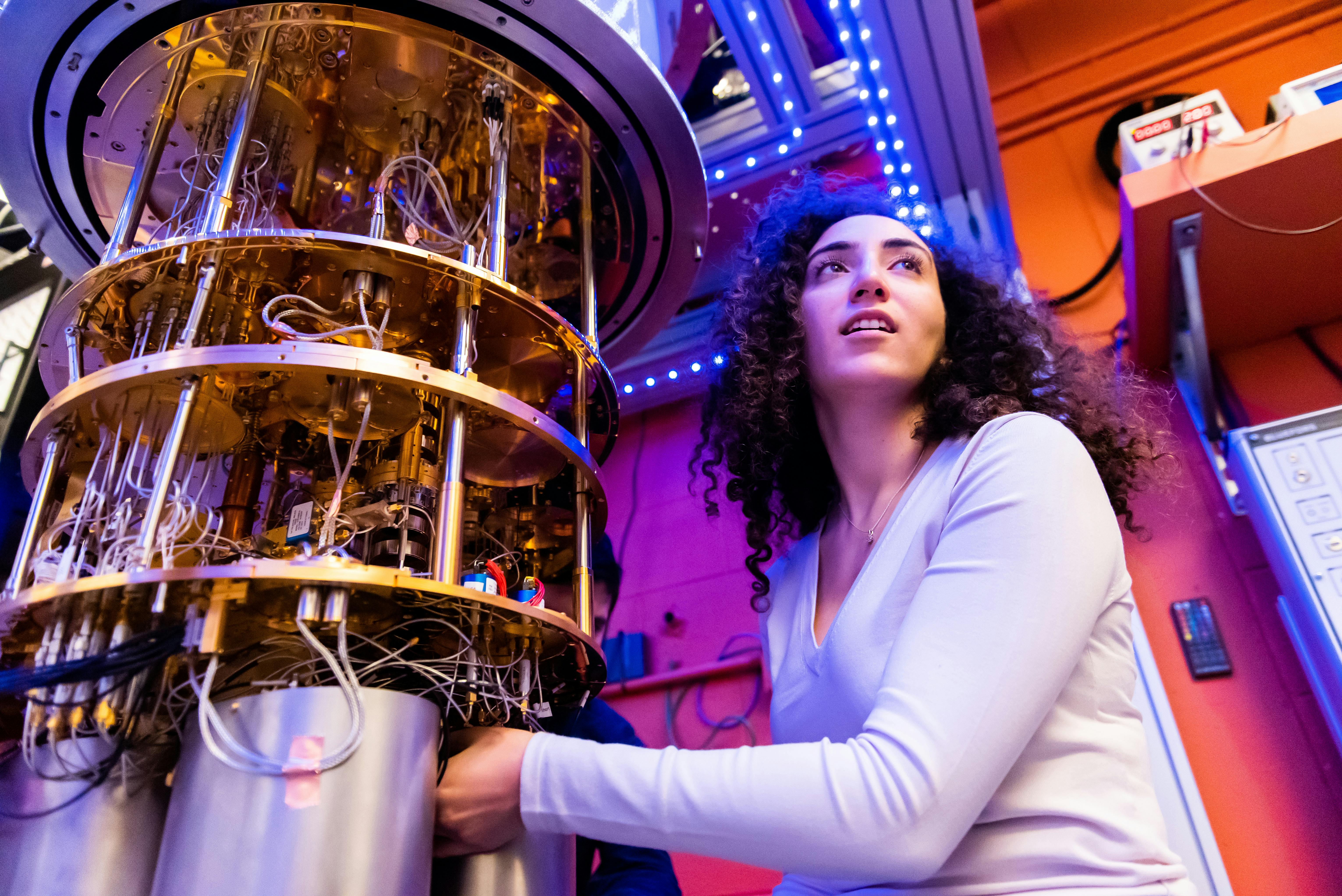 Aziza Almanakly working on the dilution refrigerator; the quantum interconnect experiment took place inside this dilution refrigerator.