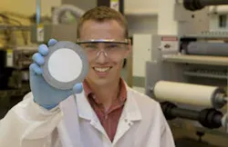 Matthew Hagedon of UC holds a sample of electrofluidic imaging film. The white plastic film, ten times thinner than a sheet of paper, is in a rigid frame for support during lamination into a display. The goal is to create a large roll of film that can be laminated onto electronics. Matthew Hagedon of UC holds a sample of electrofluidic imaging film. The white plastic film, ten times thinner than a sheet of paper, is in a rigid frame for support during lamination into a display. The goal is to create a large roll of film that can be laminated onto electronics.