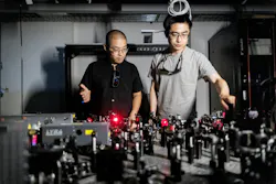 FIGURE 3. Bo Zhen (left) and Li He (right) in the lab with the team’s ultrafast laser setup. Credit: Eric Sucar/University of Pennsylvania FIGURE 3. Bo Zhen (left) and Li He (right) in the lab with the team’s ultrafast laser setup. Credit: Eric Sucar/University of Pennsylvania