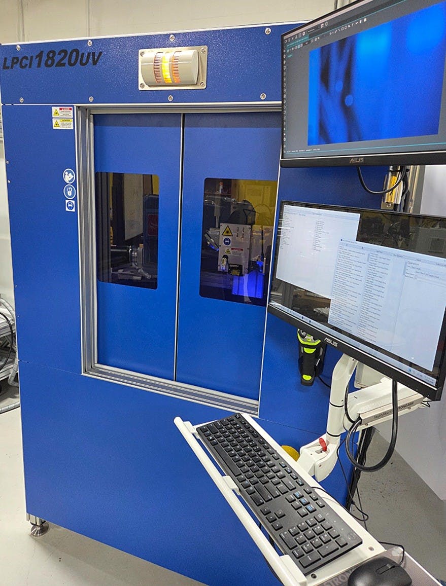 The LPCI1820UV Laser Precision Cleaning System features a fully enclosed Class 1 design with front access doors, side panels, and an integrated operator interface for real-time process control and monitoring.