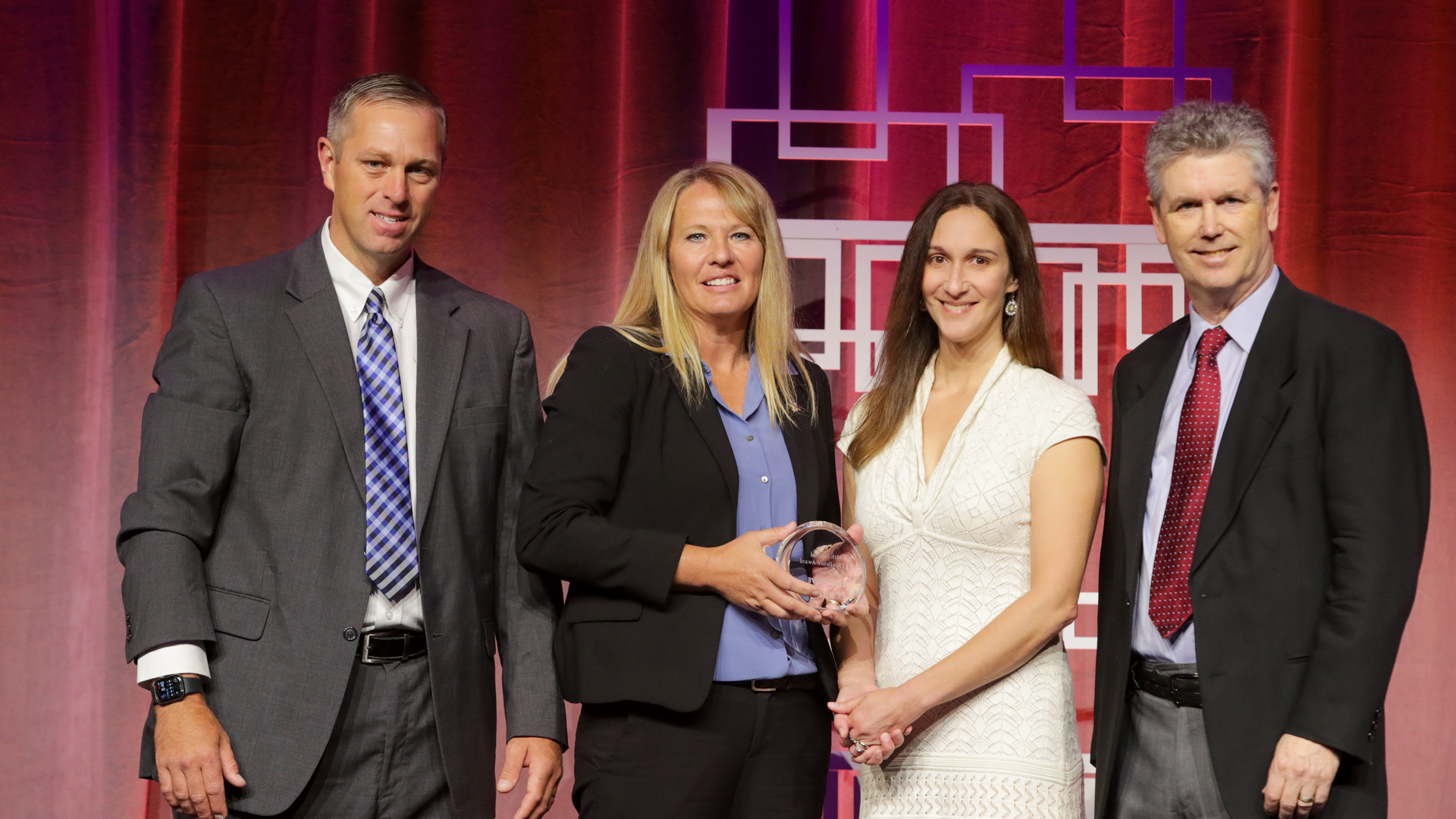 2021 FTTXcellence Award winner Barbara Sessions (second from left) is flanked by Joe Jensen of Corning Optical Communications (left), Mari Silbey of US Ignite (right) and Stephen Hardy of Lightwave.