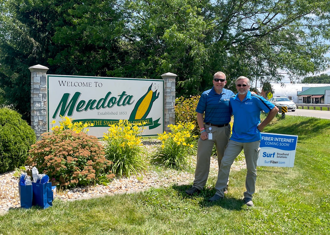 Surf Broadband Solutions CEO Gene Crusie presents Mendota Area Chamber of Commerce President/CEO Shelby Weide with the Pyramid Award as Surf team members and Mendota city officials look on during a June 28 groundbreaking event. The award signifies Surf&rsquo;s partnership with the City of Mendota to bring fiber-optic internet to the community.