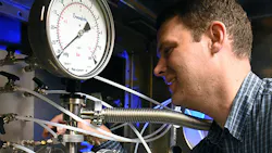 A chemist at the NRL checks the KrF laser being used to clean up emissions from coalburning power plants by destroying NOx in the flue gas A chemist at the NRL checks the KrF laser being used to clean up emissions from coalburning power plants by destroying NOx in the flue gas