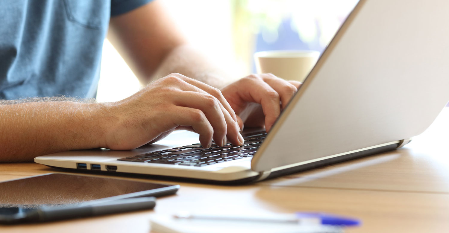 Person typing on laptop