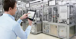 Man using tablet on a factory floor Man using tablet on a factory floor