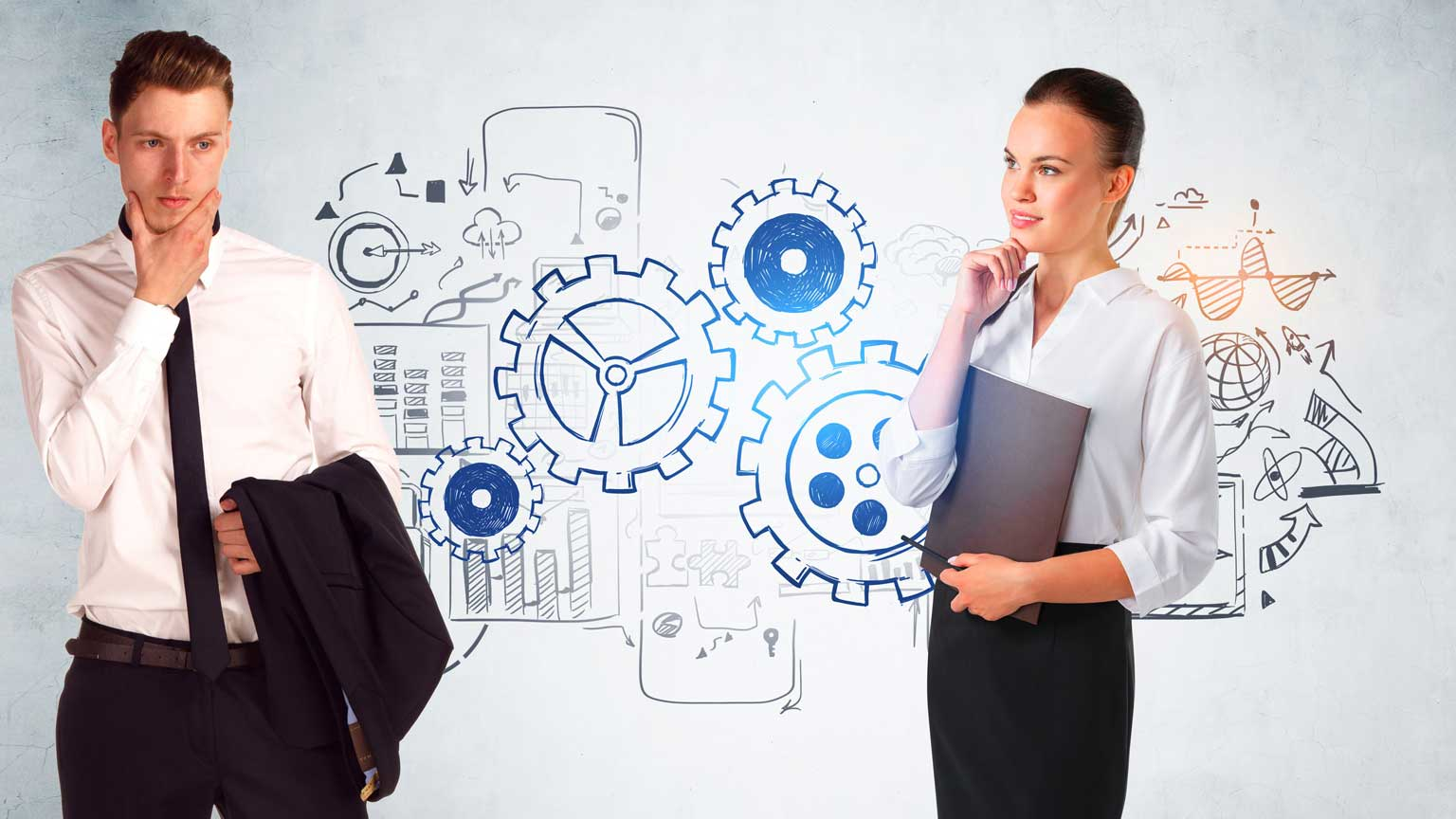 Engineers standing in front of gears sketch