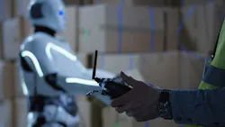 Man controlling a robot Man controlling a robot