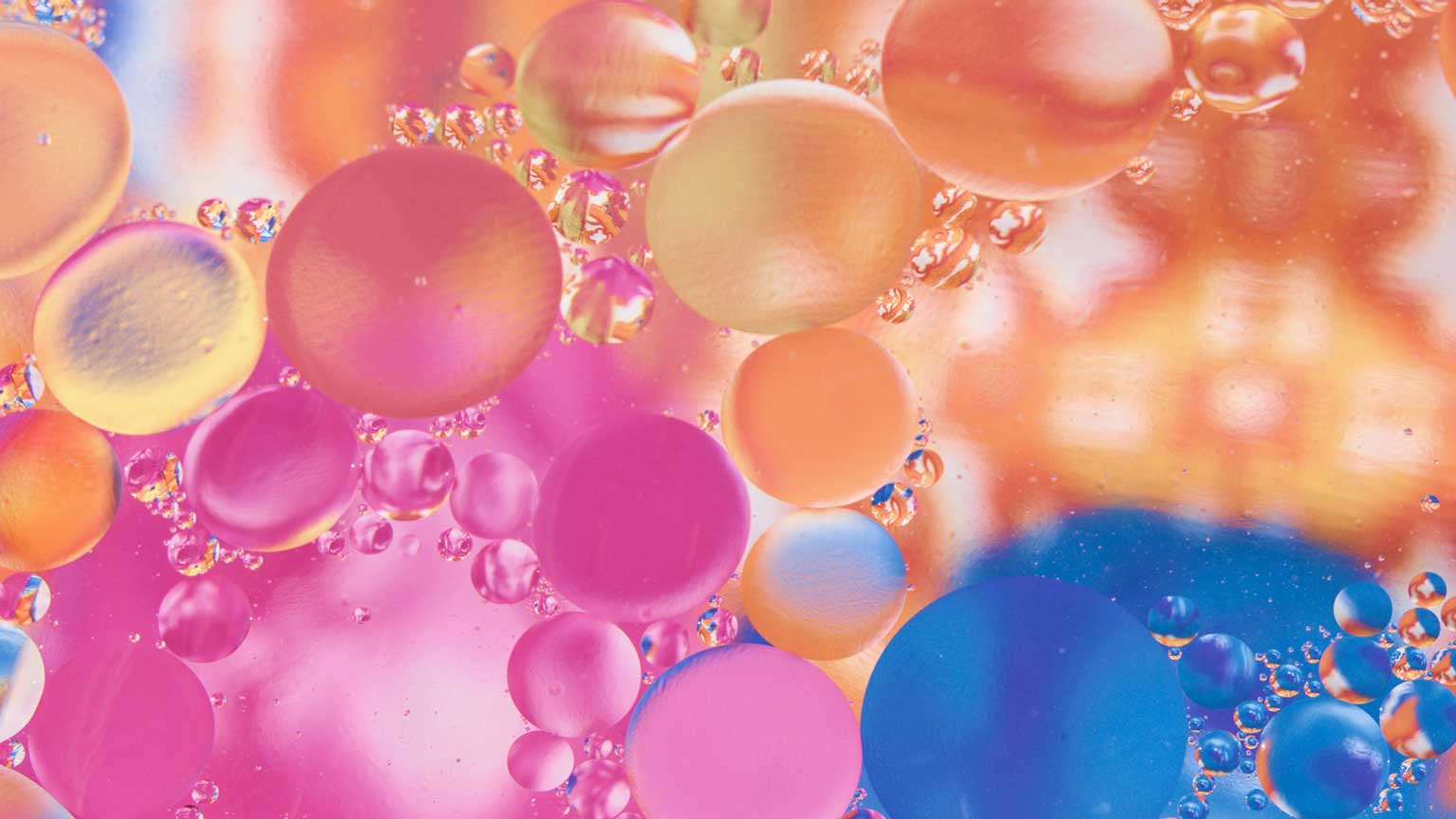 Oil mixed with water on a colored background