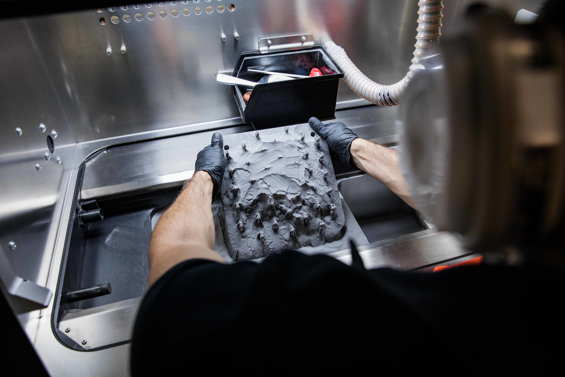 The direct metal laser sintering (DMLS) process builds parts from sintered powder. The resulting parts naturally have a textured finish that is similar to cast metal parts.