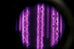 A purple glow surrounds these parts being ion (plasma) nitrided. It is caused by ionized and excited nitrogen molecules and atoms bombarding the part surface due to the applied potential. Only surfaces exposed to the plasma are nitrided. A purple glow surrounds these parts being ion (plasma) nitrided. It is caused by ionized and excited nitrogen molecules and atoms bombarding the part surface due to the applied potential. Only surfaces exposed to the plasma are nitrided.