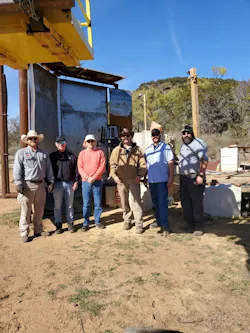 The metal sheet wall behind Dr. John Granier and his colleagues is a stationary fragmenting warhead test. High speed video records the time of arrival and pattern as fragments penetrate the metal wall. The metal sheet wall behind Dr. John Granier and his colleagues is a stationary fragmenting warhead test. High speed video records the time of arrival and pattern as fragments penetrate the metal wall.