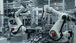 Industrial robotic arms working on an automated assembly line Industrial robotic arms working on an automated assembly line