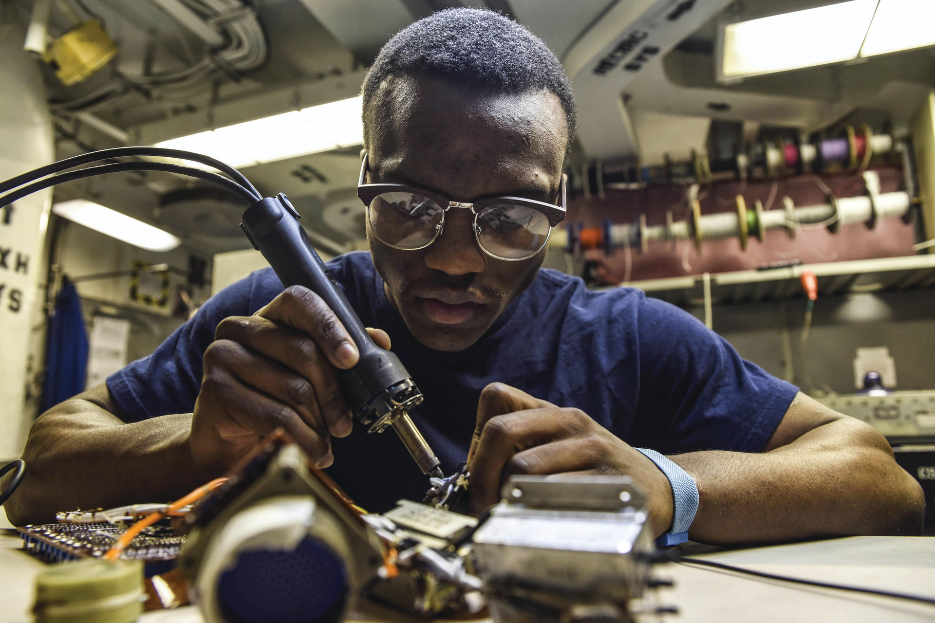 A Navy petty officer desolders a flex print assembly in the avionics shop of the aircraft carrier USS Dwight D. Eisenhower in the Persian Gulf.