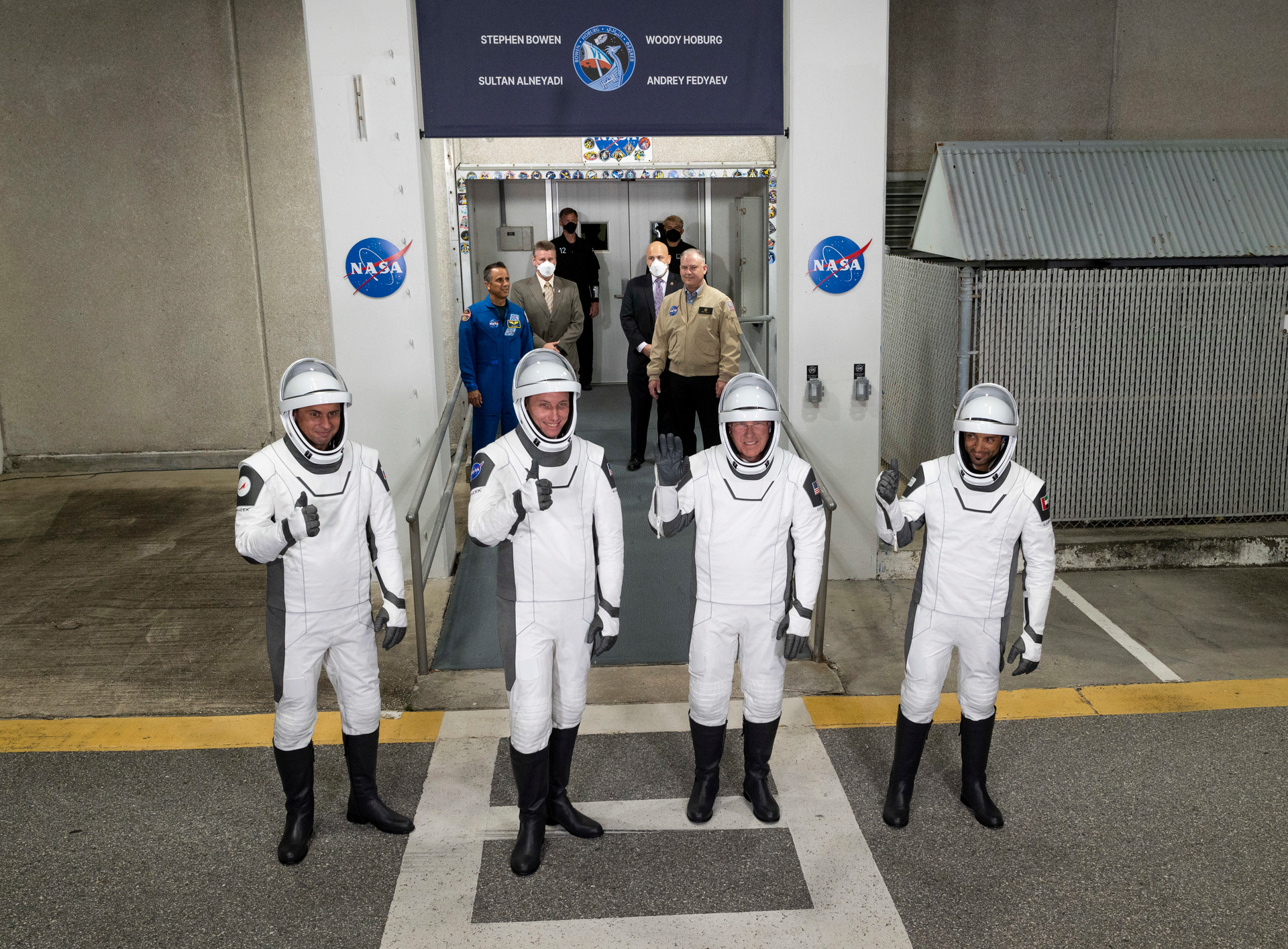 Cut: Roscosmos cosmonaut Andrey Fedyaev, left, NASA astronaut Warren &ldquo;Woody' Hoburg, second from left, NASA astronaut Stephen Bowen, second from right, and UAE (United Arab Emirates) astronaut Sultan Alneyadi, right, wearing SpaceX spacesuits, are seen as they prepare to depart the Neil A. Armstrong Operations and Checkout Building for Launch Complex 39A to board the SpaceX Dragon spacecraft for the Crew-6 mission launch, Wednesday, March 1, 2023, at NASA&rsquo;s Kennedy Space Center in Florida. Photo by NASA/Joel Kowsky.
