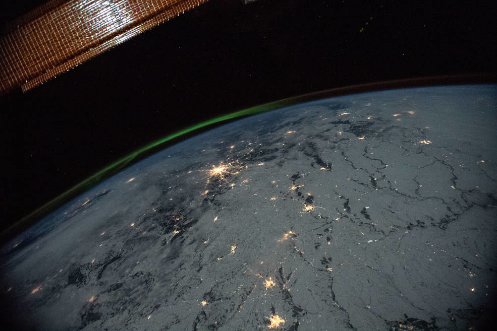 A portion of the International Space Station's solar arrays caps this nighttime view of Earth with aurora as the orbital complex orbited 258 miles above Ukraine and Russia. NASA image.
