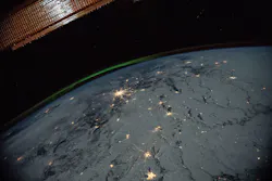 A portion of the International Space Station's solar arrays caps this nighttime view of Earth with aurora as the orbital complex orbited 258 miles above Ukraine and Russia. NASA image. A portion of the International Space Station's solar arrays caps this nighttime view of Earth with aurora as the orbital complex orbited 258 miles above Ukraine and Russia. NASA image.