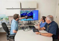 NASA lead software developer, Ethan Williams, left, pilot Scott Howe, and operations test consultant Jan Scofield run a flight path management software simulation at NASA’s Armstrong Flight Research Center in Edwards, California. NASA photo. NASA lead software developer, Ethan Williams, left, pilot Scott Howe, and operations test consultant Jan Scofield run a flight path management software simulation at NASA’s Armstrong Flight Research Center in Edwards, California. NASA photo.