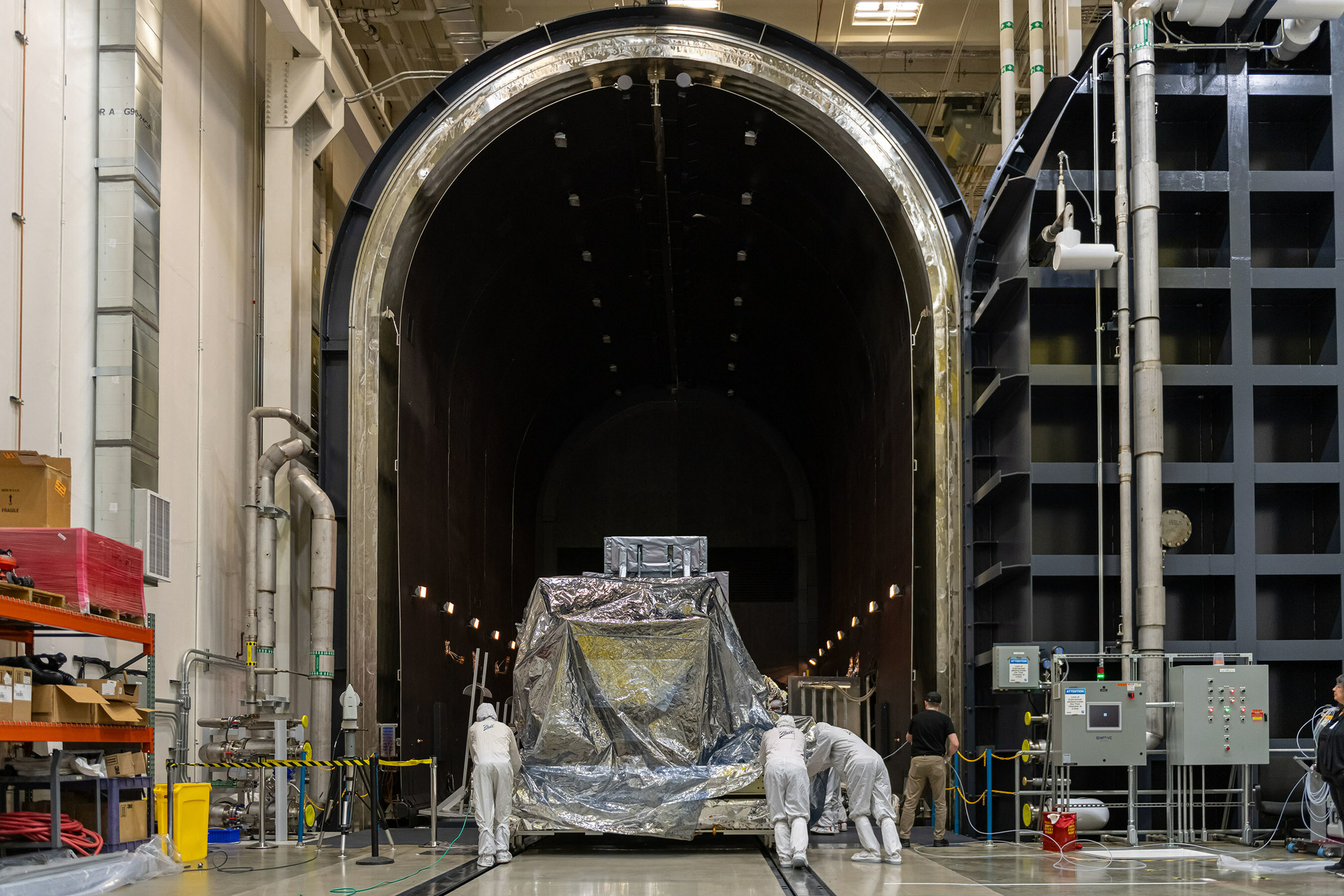 After completing final integration, Ball Aerospace technicians transport the Nancy Grace Roman Space Telescope's Wide Field Instrument (WFI) into Ball&rsquo;s largest thermal vacuum chamber to begin environmental testing at a Ball facility in Boulder, Colorado. Ball photo.
