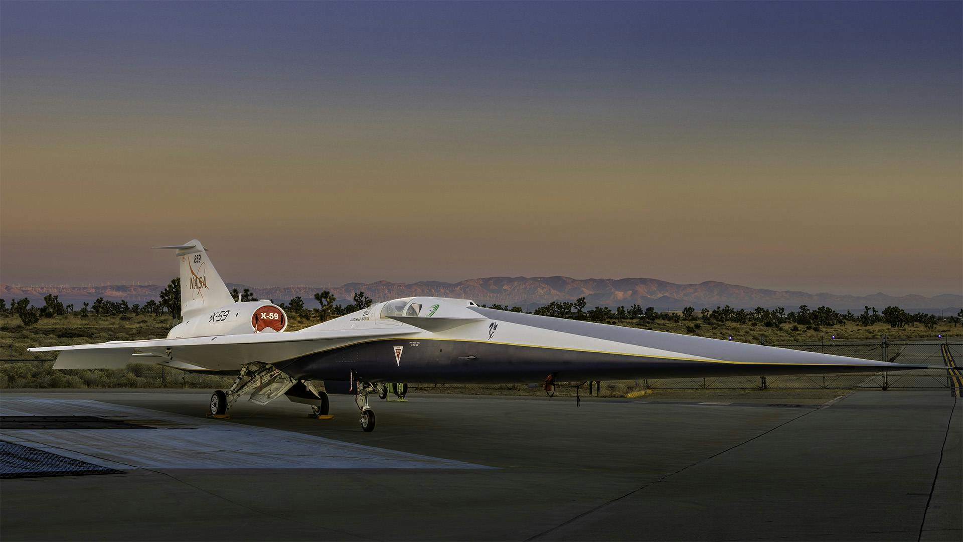 NASA&rsquo;s X-59 quiet supersonic research aircraft sits on the apron outside Lockheed Martin&rsquo;s Skunk Works facility at dawn in Palmdale, California. The X-59 is the centerpiece of NASA&rsquo;s Quesst mission, which seeks to address one of the primary challenges to supersonic flight over land by making sonic booms quieter. Lockheed Martin Skunk Works photo.