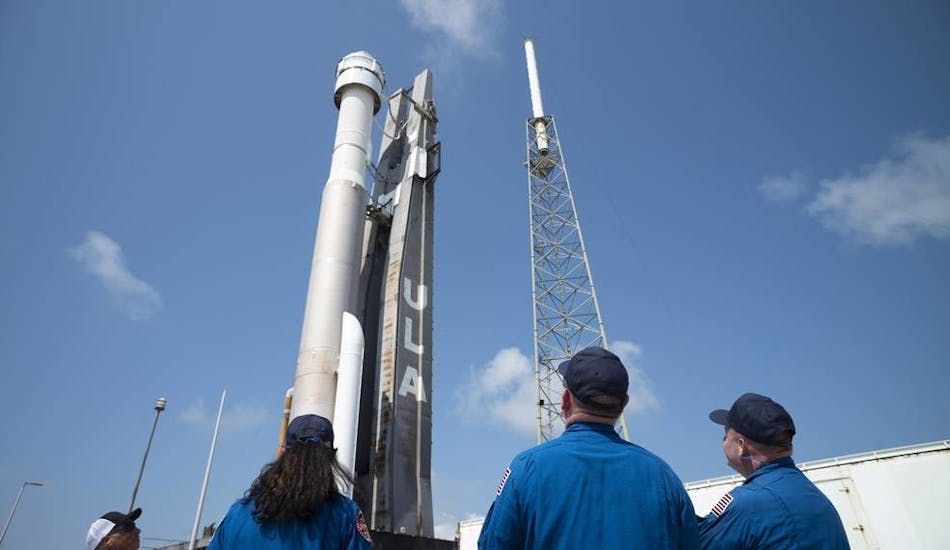 NASA astronauts Suni Williams, left, Barry 'Butch' Wilmore, center, and Mike Fincke, right, watch as a United Launch Alliance Atlas V rocket with Boeing&rsquo;s CST-100 Starliner spacecraft aboard is rolled out of the Vertical Integration Facility to the launch pad at Space Launch Complex 41 ahead of the Orbital Flight Test-2 (OFT-2) mission in May 2022, at Cape Canaveral Space Force Station in Florida. ULA photo.