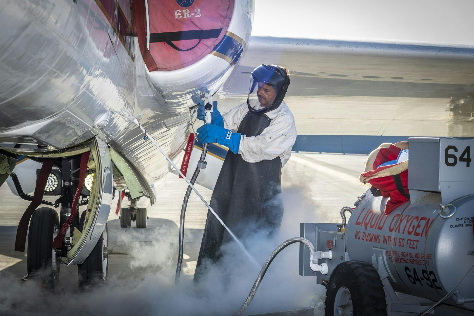 Francisco Rodriguez (aircraft mechanic) services liquid oxygen or LOX on the ER-2 during the Geological Earth Mapping Experiment (GEMx) research project. Experts like Rodriguez sustain a high standard of safety on airborne science aircraft like the ER-2 and science missions like GEMx. The ER-2 is based out of NASA&rsquo;s Armstrong Flight Research Center in Edwards, California. NASA/Steve Freeman photo.