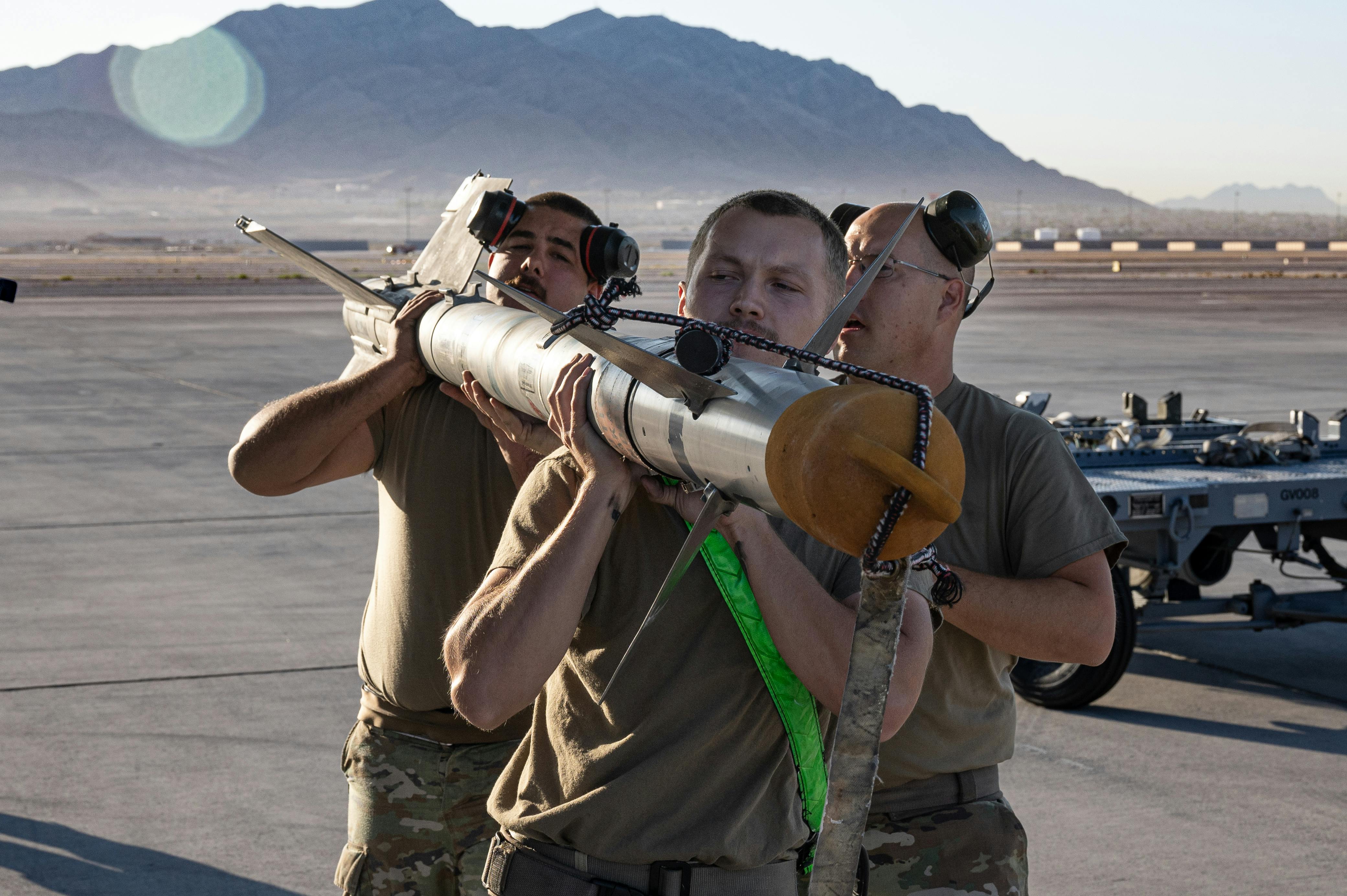 An Aim 9x Infrared Guided Air To Air Missile Is Loaded Onto A Us Military Combat Aircraft