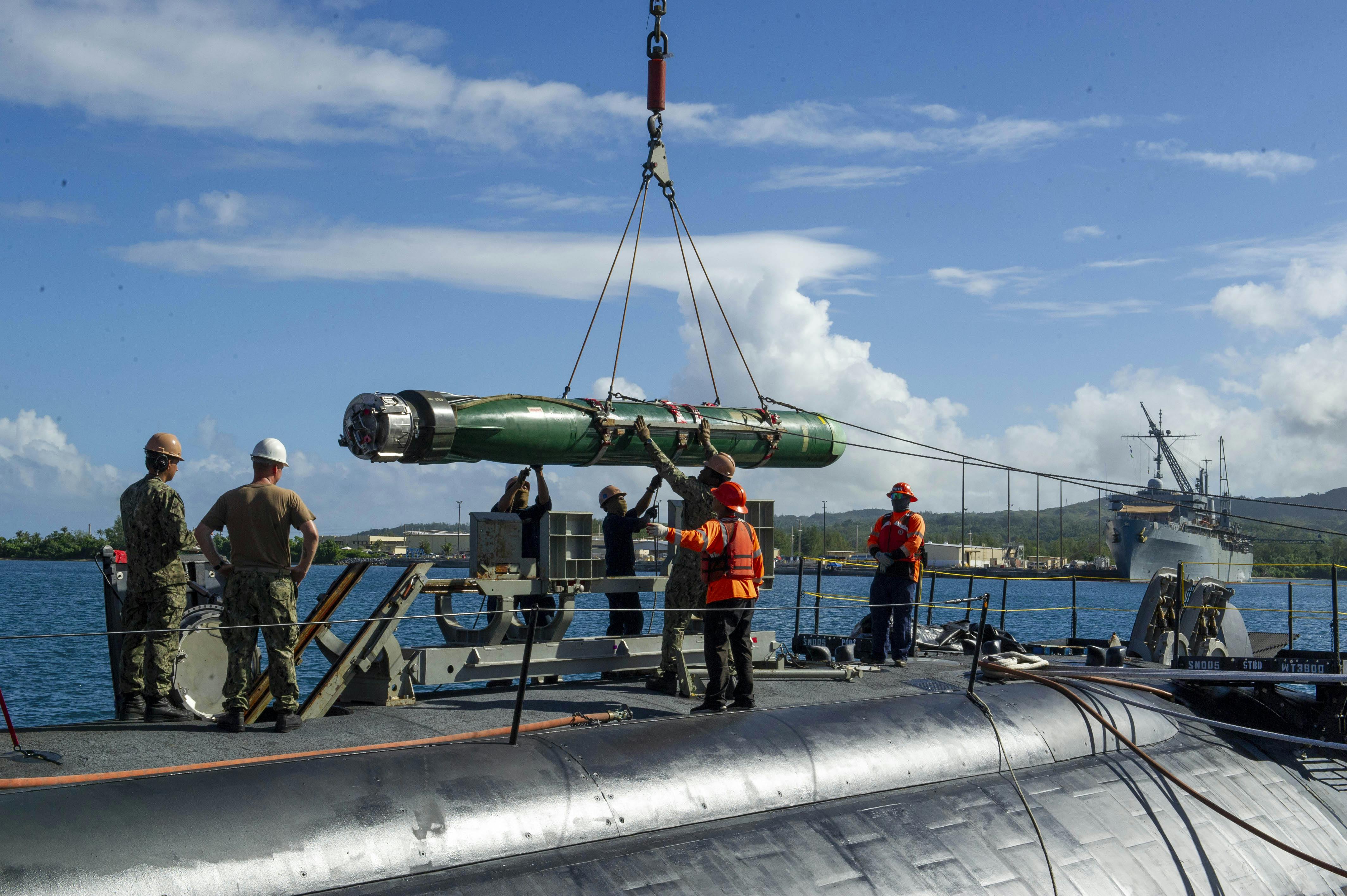 Sailors load a MK 48 torpedo aboard the Los Angeles-class attack submarine USS Annapolis.