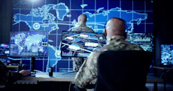 Cyber technology operator monitoring surveillance cameras in military control center. Cyber technology operator monitoring surveillance cameras in military control center.