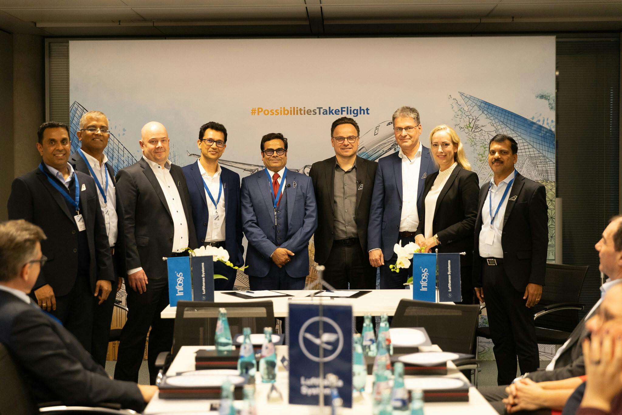 A group photo of businesspeople standing.