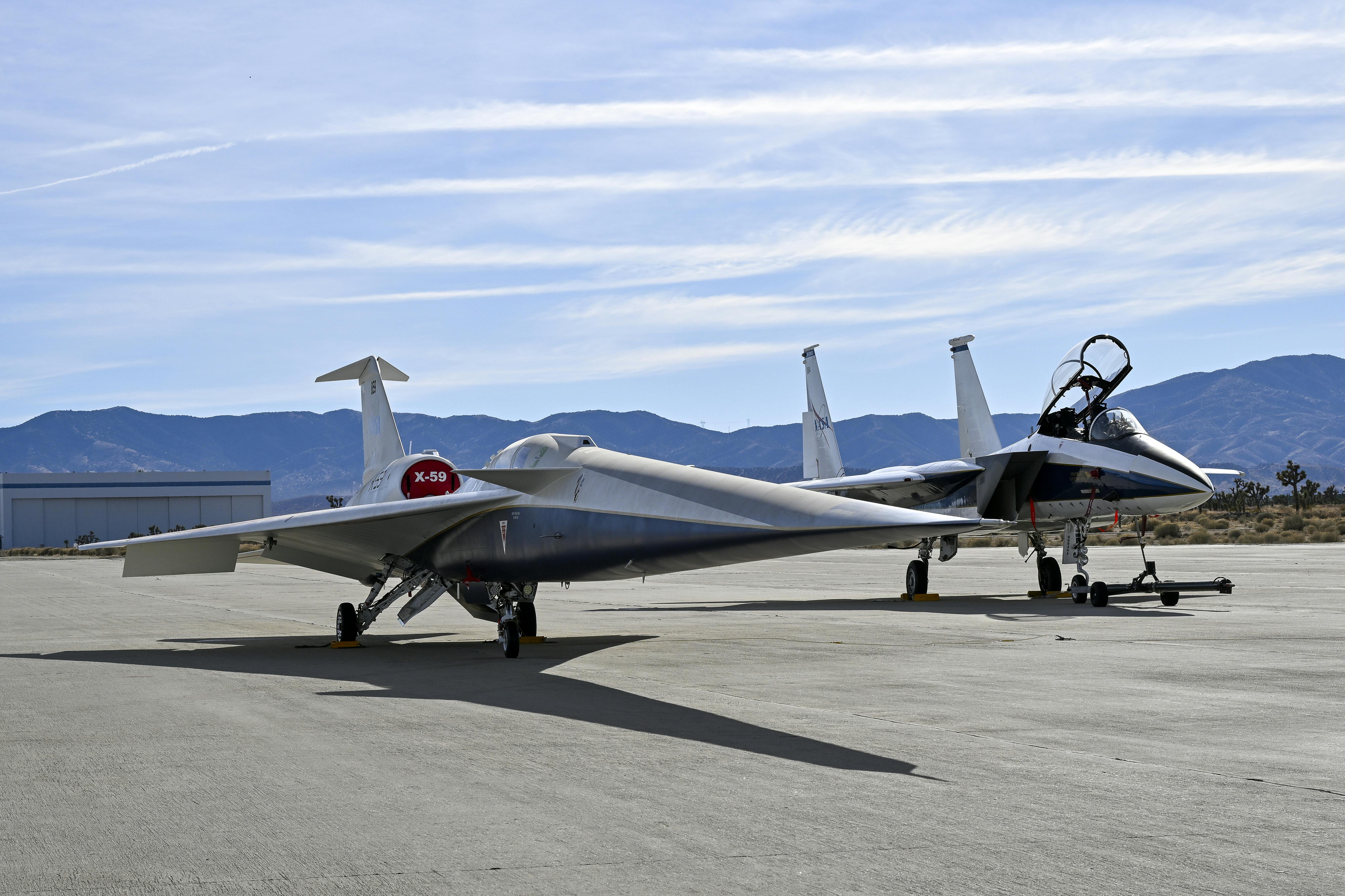 NASA&rsquo;s F-15D research aircraft is positioned next to the X-59 during electromagnetic compatibility testing at U.S. Air Force Plant 42 in Palmdale, California. Researchers activated the F-15D&rsquo;s radar, C-band transponder, and radios at varying distances from the X-59 to assess potential electromagnetic interference with the aircraft&rsquo;s flight-critical systems, ensuring the X-59 can operate safely alongside other aircraft. These tests indicated that the aircraft&rsquo;s integration is progressing and cleared a significant hurdle, moving it one step closer to its first flight. NASA/Carla Thomas photo.