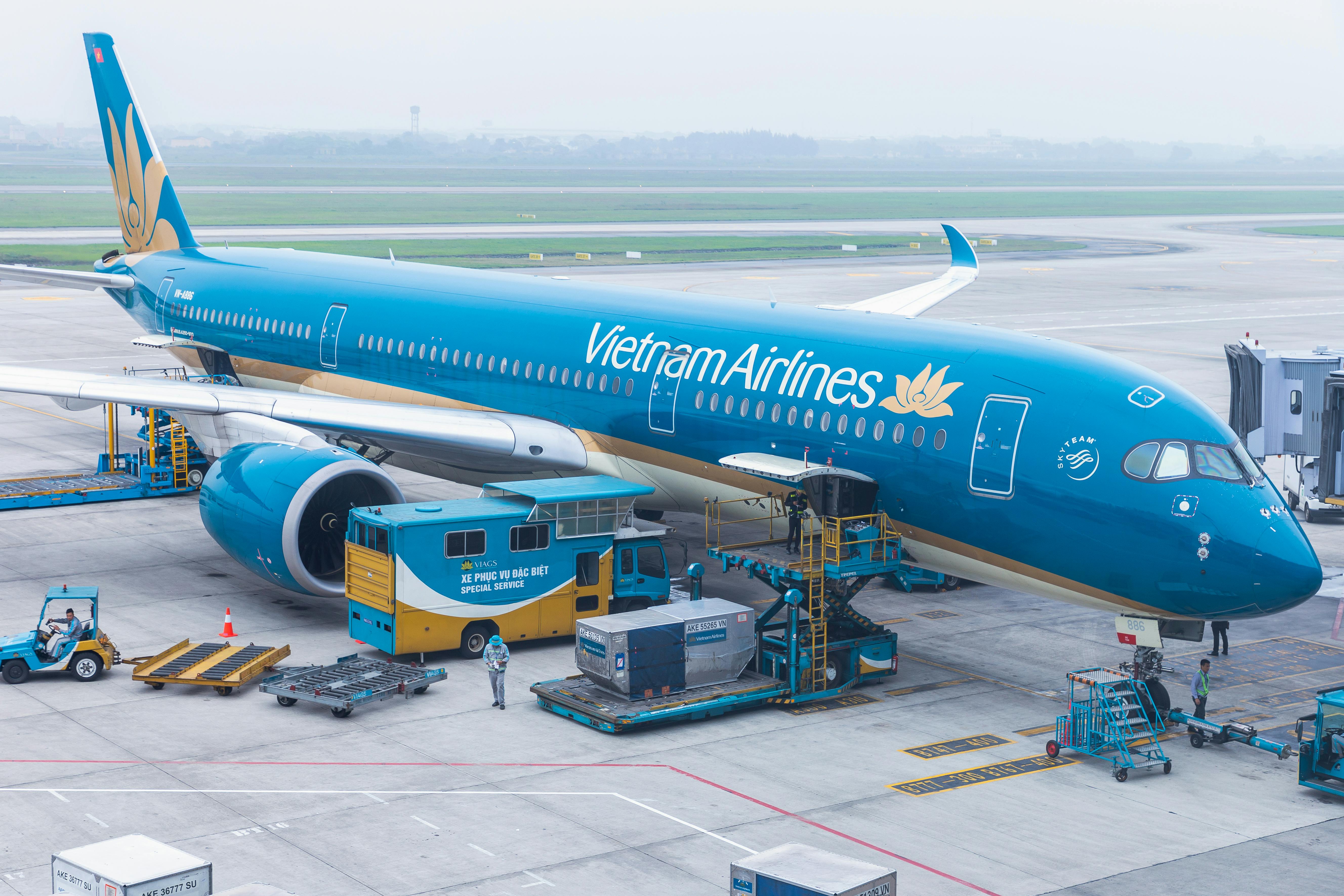 A Vietnam Airlines passenger jet parked at an airport gate