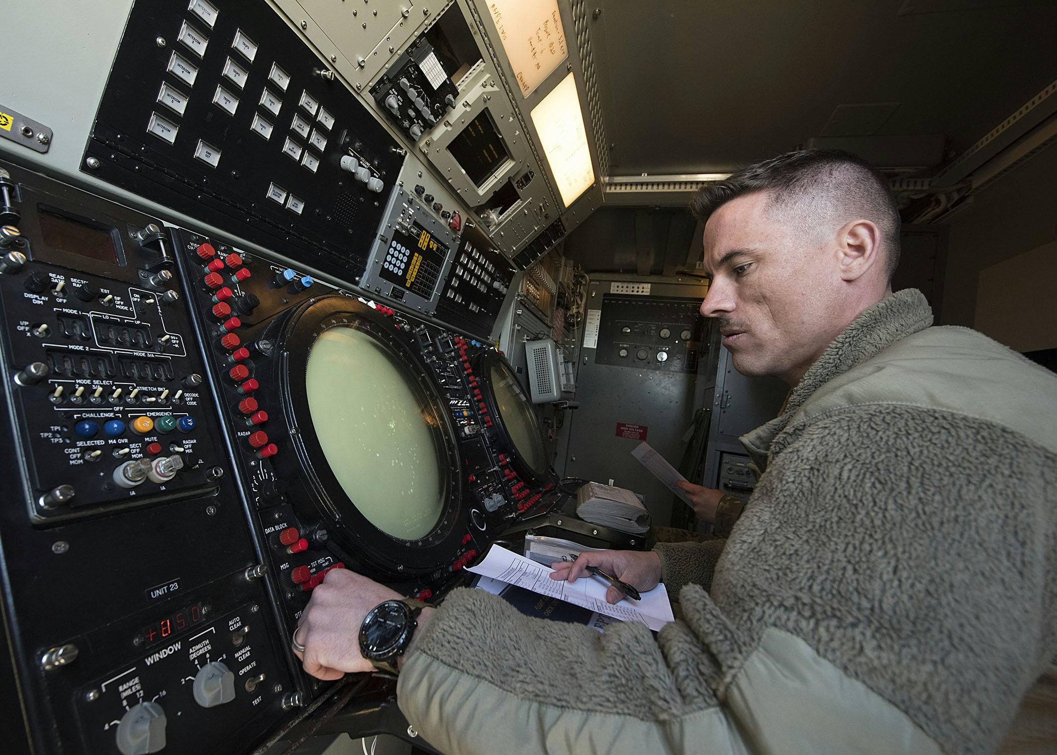 A U.S. Air Force battle management operator looks over a radar on the Nevada Test and Training Range during mobile decentralized command and control of joint operations.