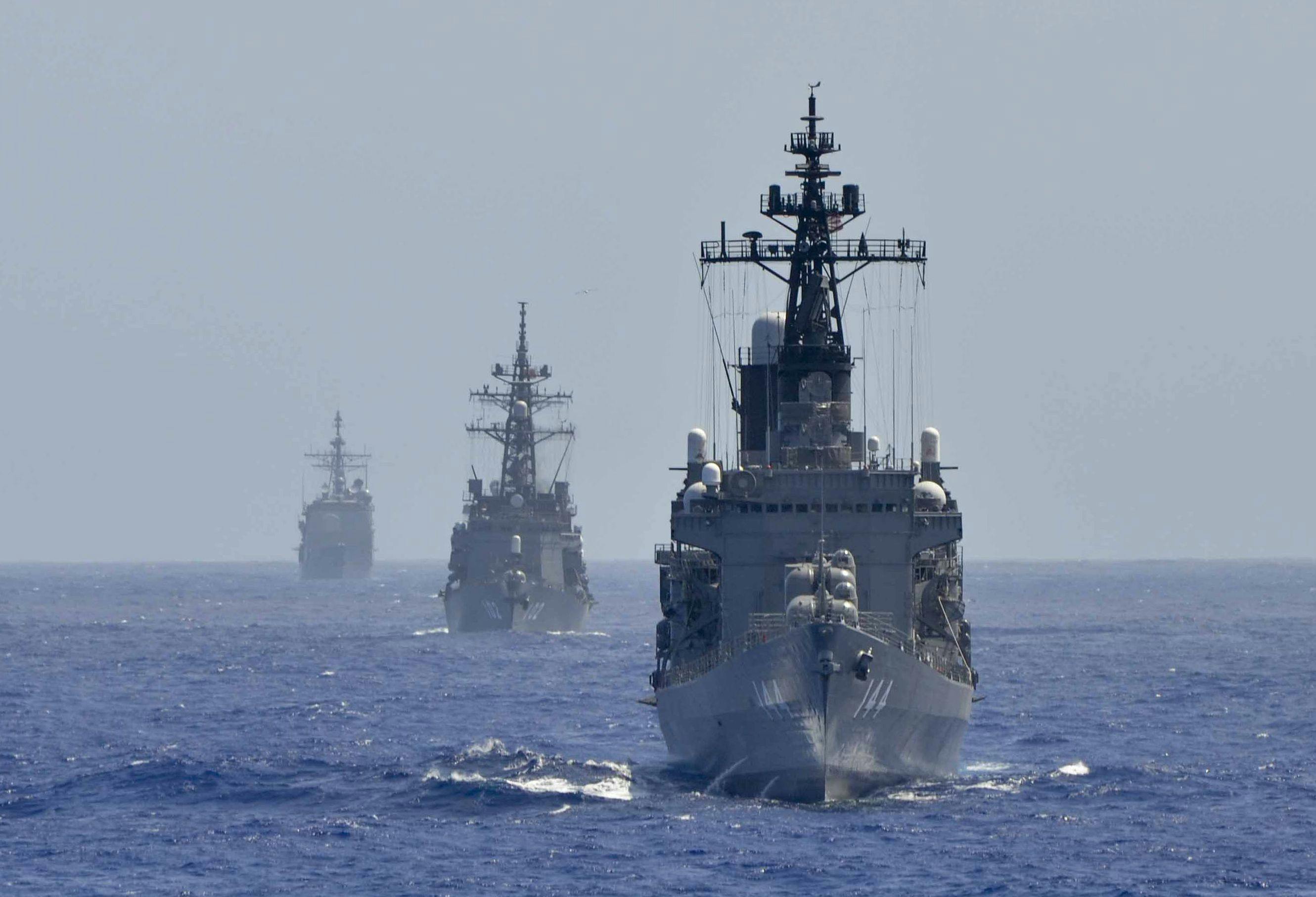 U.S. and allied surface warships sail in formation to conduct an air-defense exercise aimed at interoperability during realistic shared training.