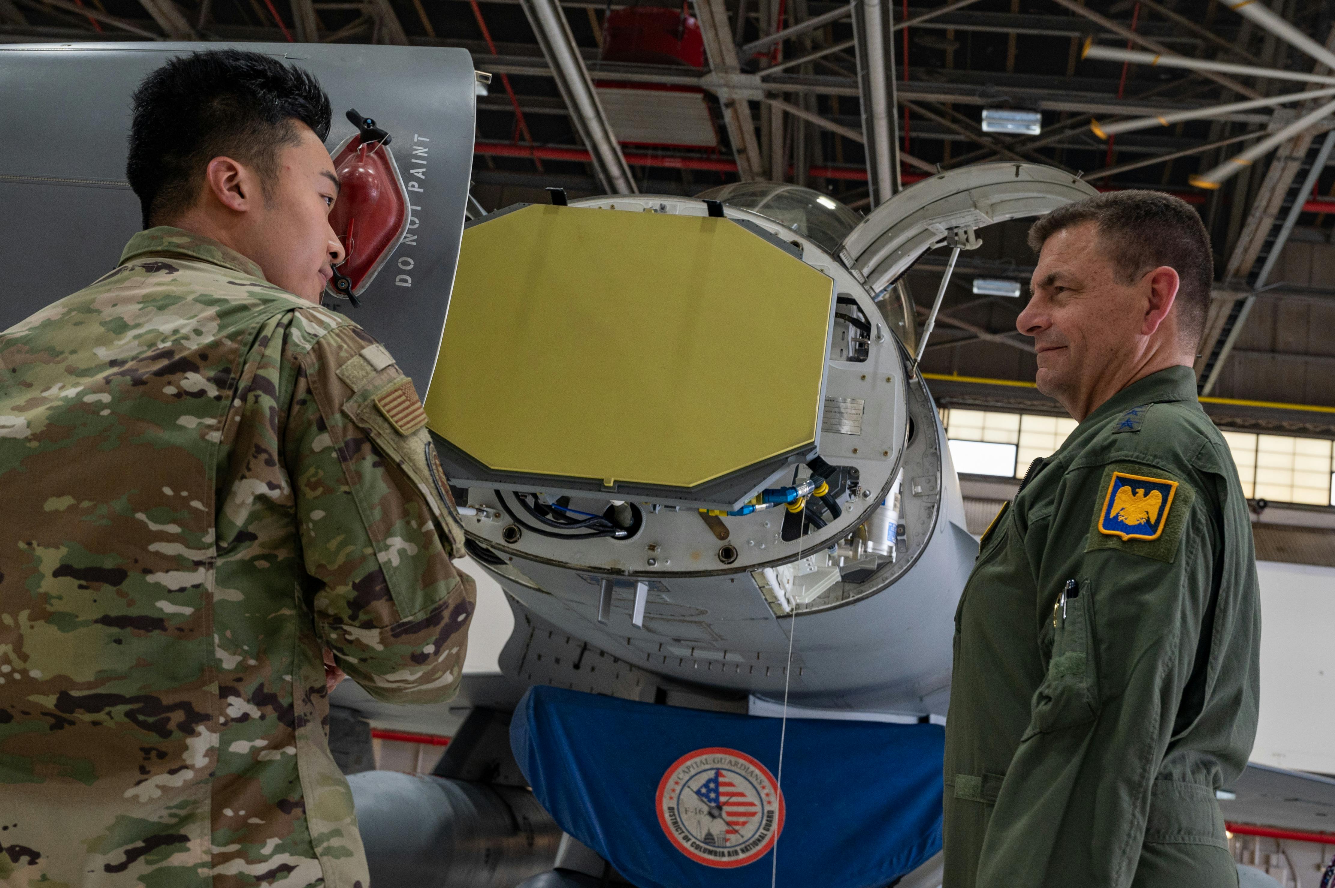A U.S. Air Force avionics specialist conducts a briefing of the active electronically scanned array (AESA) radar on F-16 jet fighter at Joint Base Andrews, Md., in 2022.
