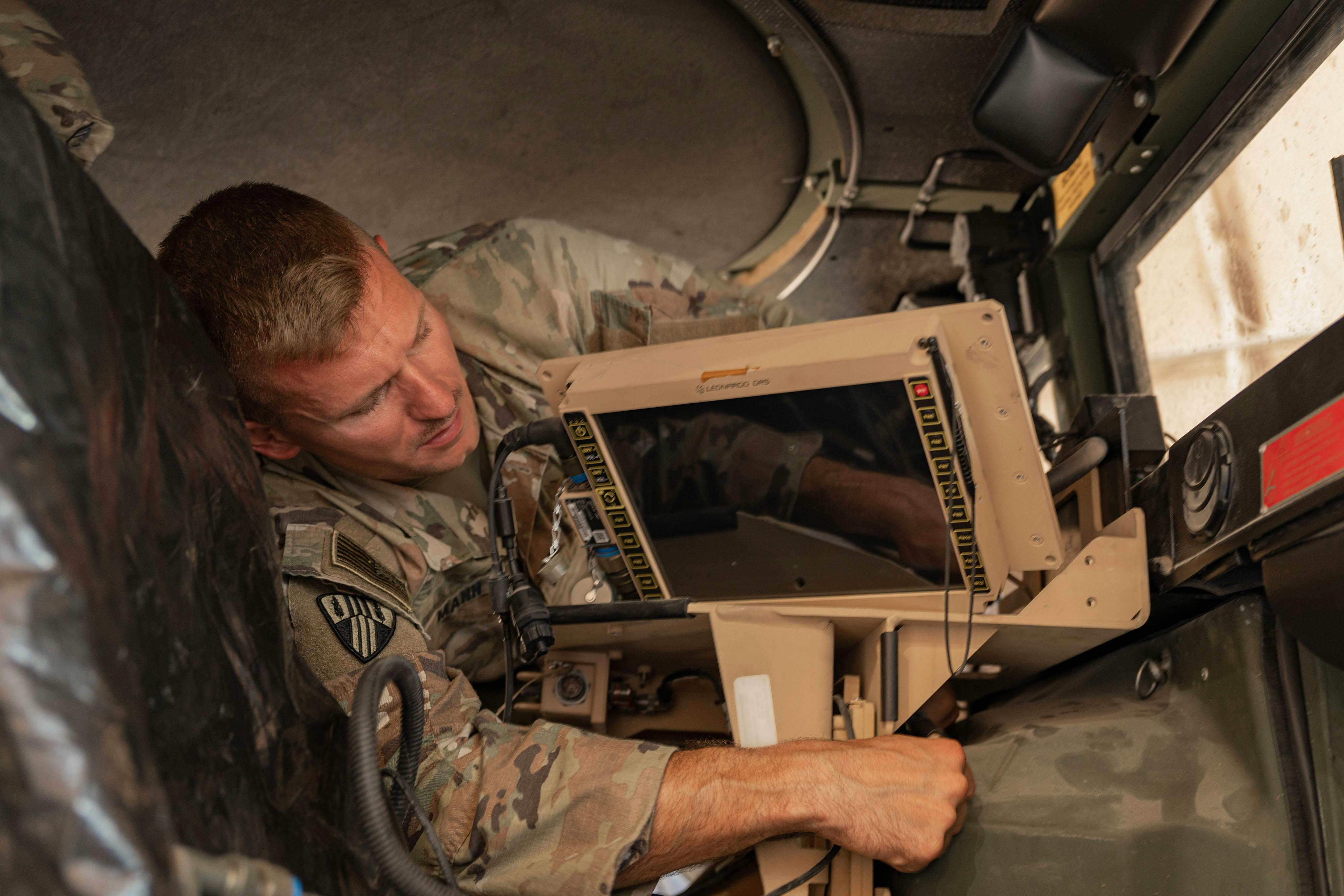 An Army signal support systems specialist installs a Joint Battle Command&ndash;Platform (JBC-P) during a communications exercise in Kuwait.