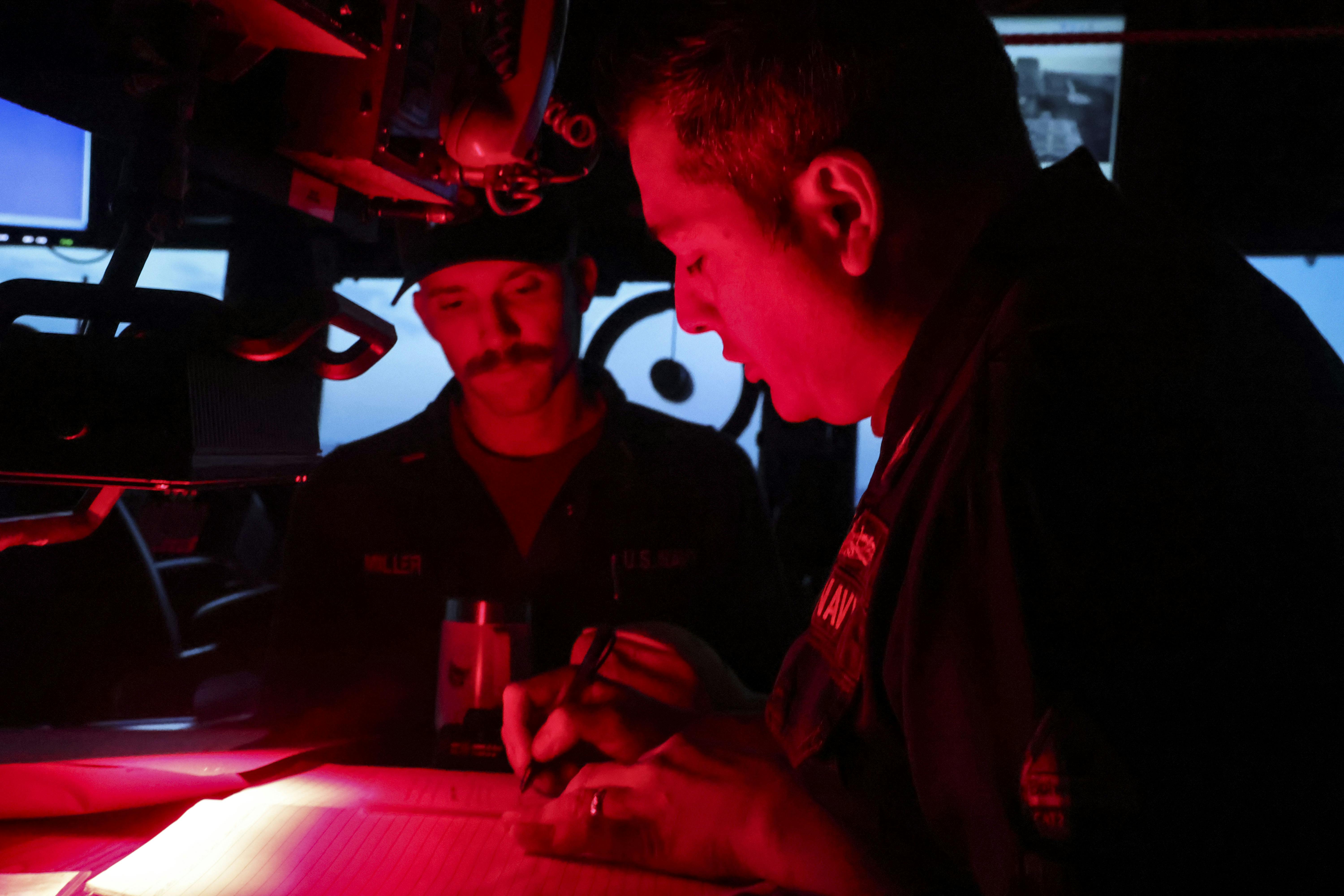 The captain of the destroyer USS Bulkeley (DDG 84) reviews log books during a deployment to support the warfighting effectiveness.
