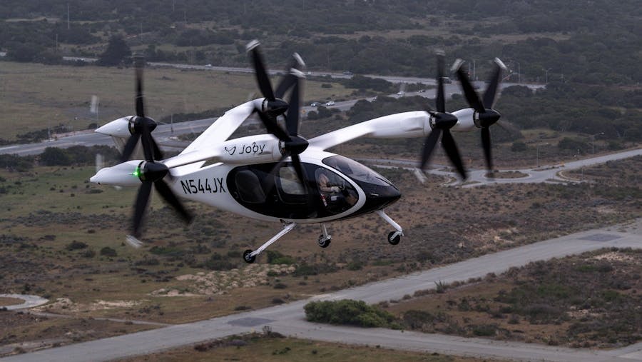 Joby test pilot James &ldquo;Buddy&rdquo; Denham flying a fully transitioned Joby aircraft above the company&rsquo;s facilities in Marina, California. Photo: Joby Aviation.