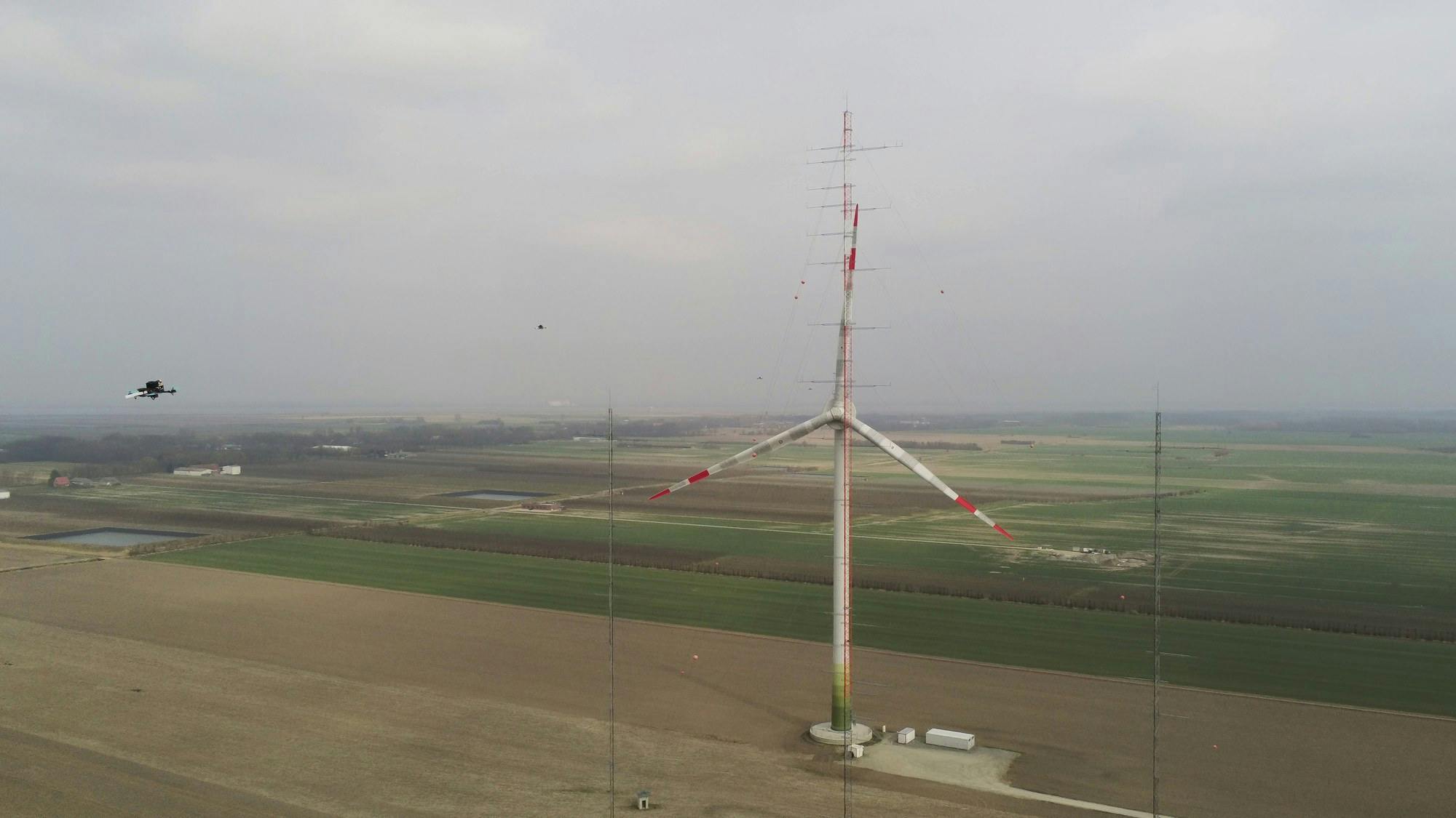 In spring 2025, a swarm of drones carried out measurements directly in front of and behind the OPUS 1 and OPUS 2 wind turbines at DLR's WiValdi wind energy research farm in Krummendeich. Credit: DLR (CC BY-NC-ND 3.0)