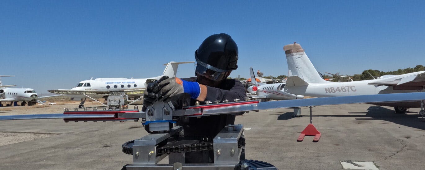 A worker attends to the fuel cell on tarmac