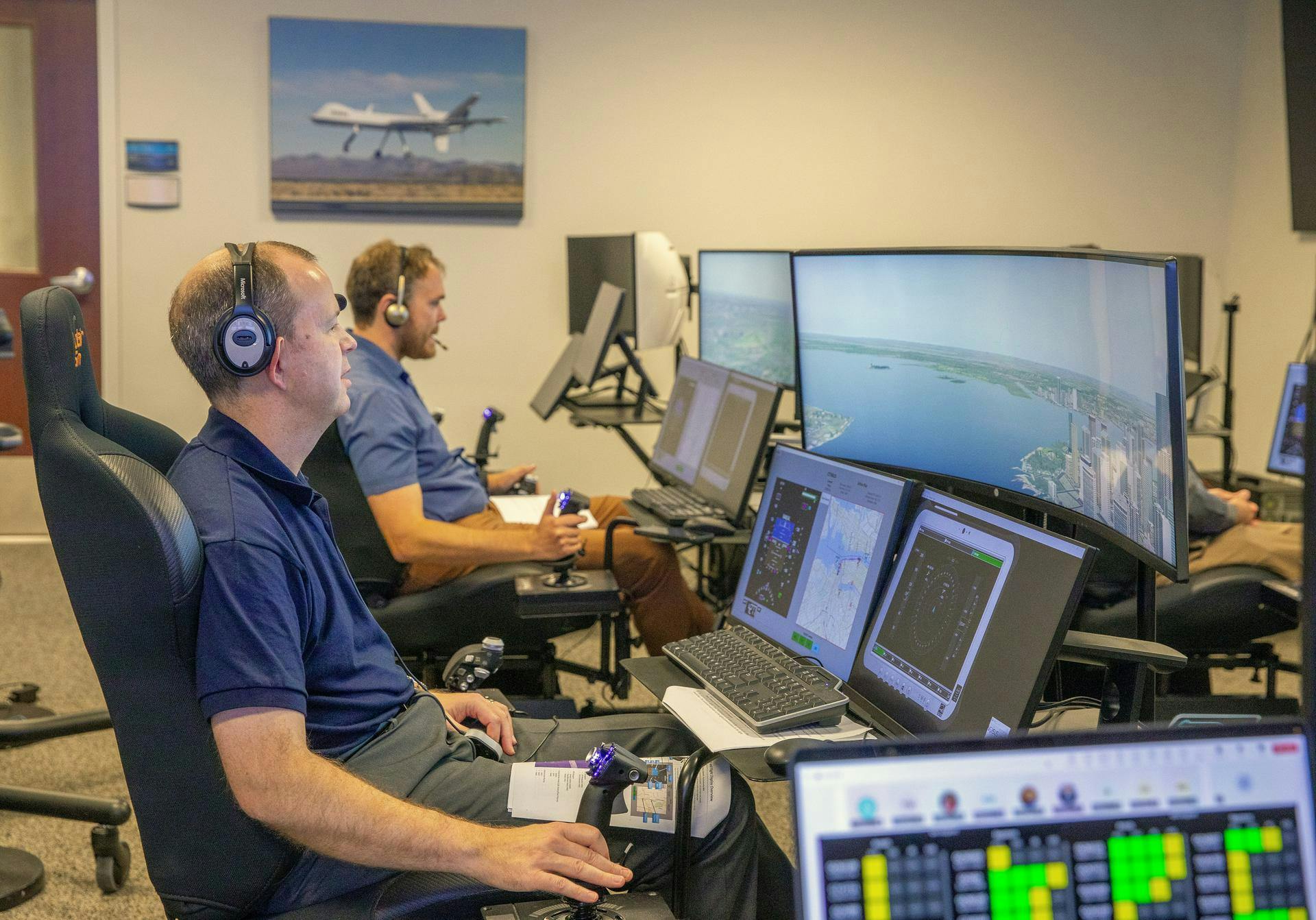 Andy Burroughs (left) and Paul Friz in the roles of air taxi pilots running through air taxi integration simulations focusing on urban air space at NASA&rsquo;s Langley Research in Hampton, Virginia on 25 Sept. 2024. NASA photo.