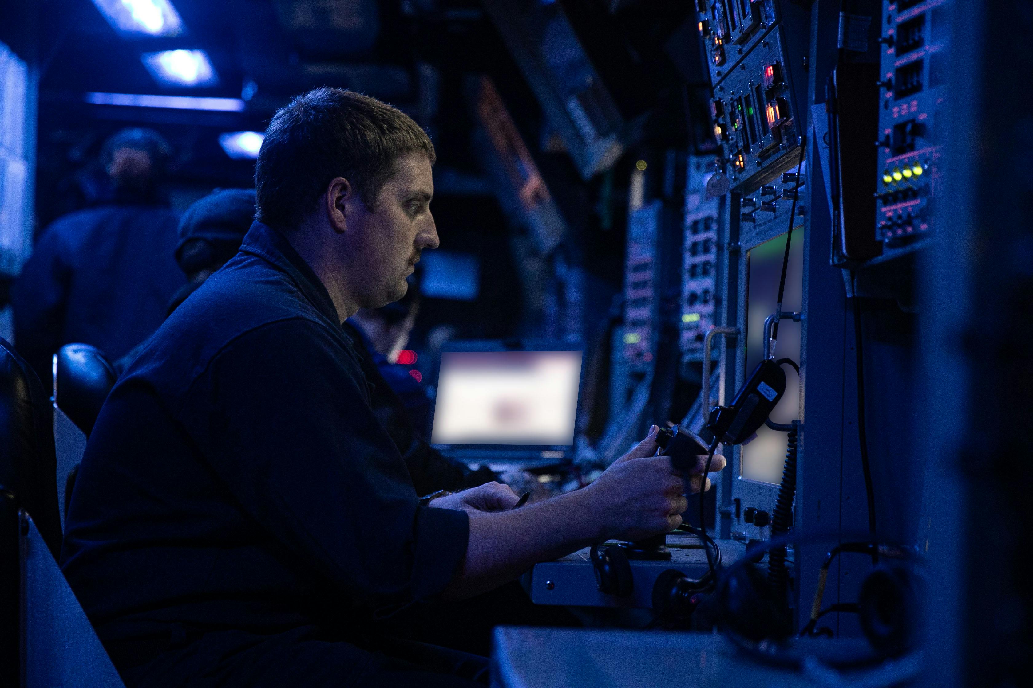 A U.S. Navy sailor stands watch in the combat information center aboard the Arleigh Burke-class guided-missile destroyer USS Wayne E. Meyer (DDG 108) last month. The ship uses the CEC battle-management and networking system.
