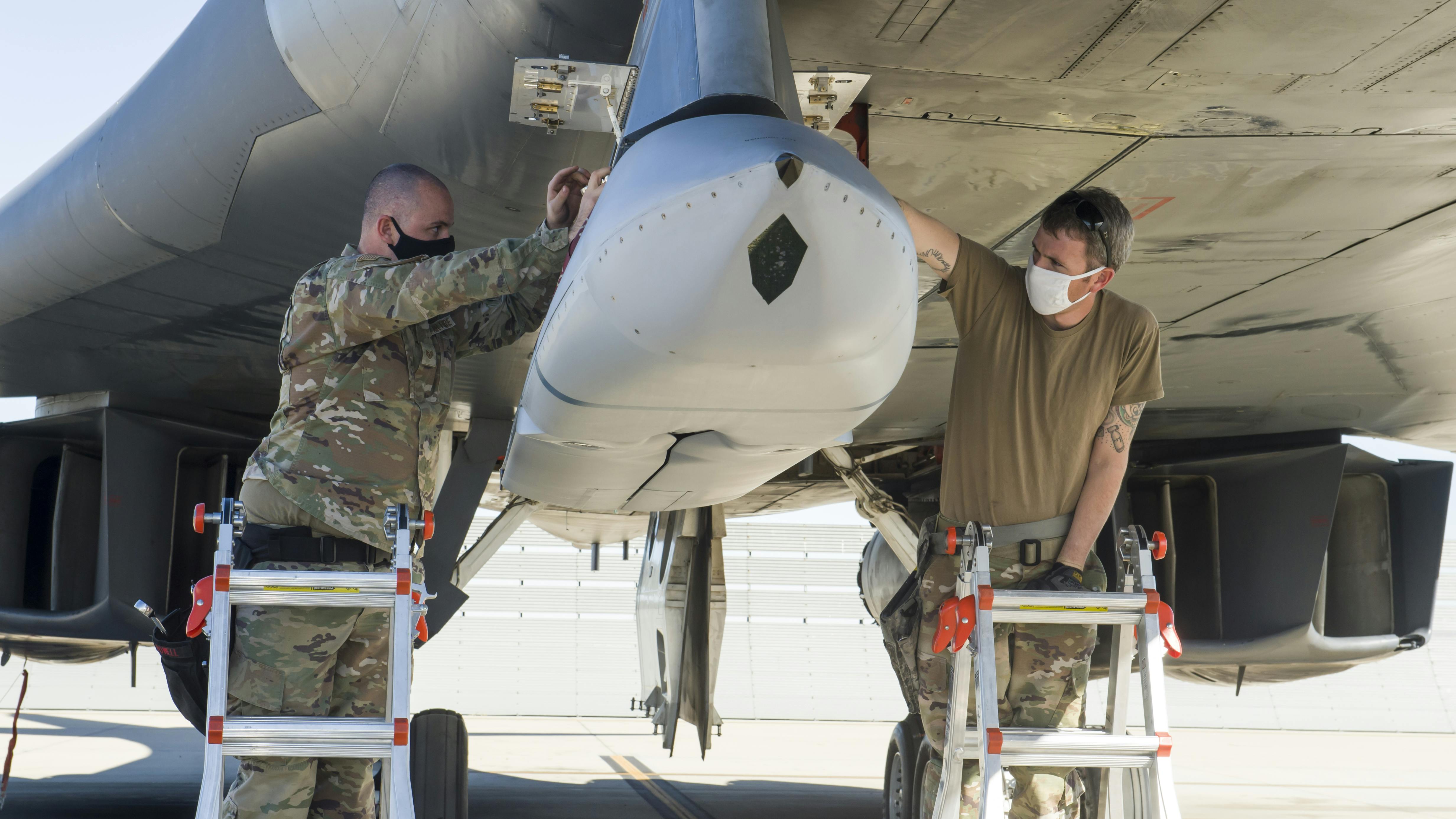 A weapon loader crew uploads a Joint Air-to-Surface Standoff Missile to an external pylon on a B-1B Lancer at Edwards Air Force Base, Calif., last December.