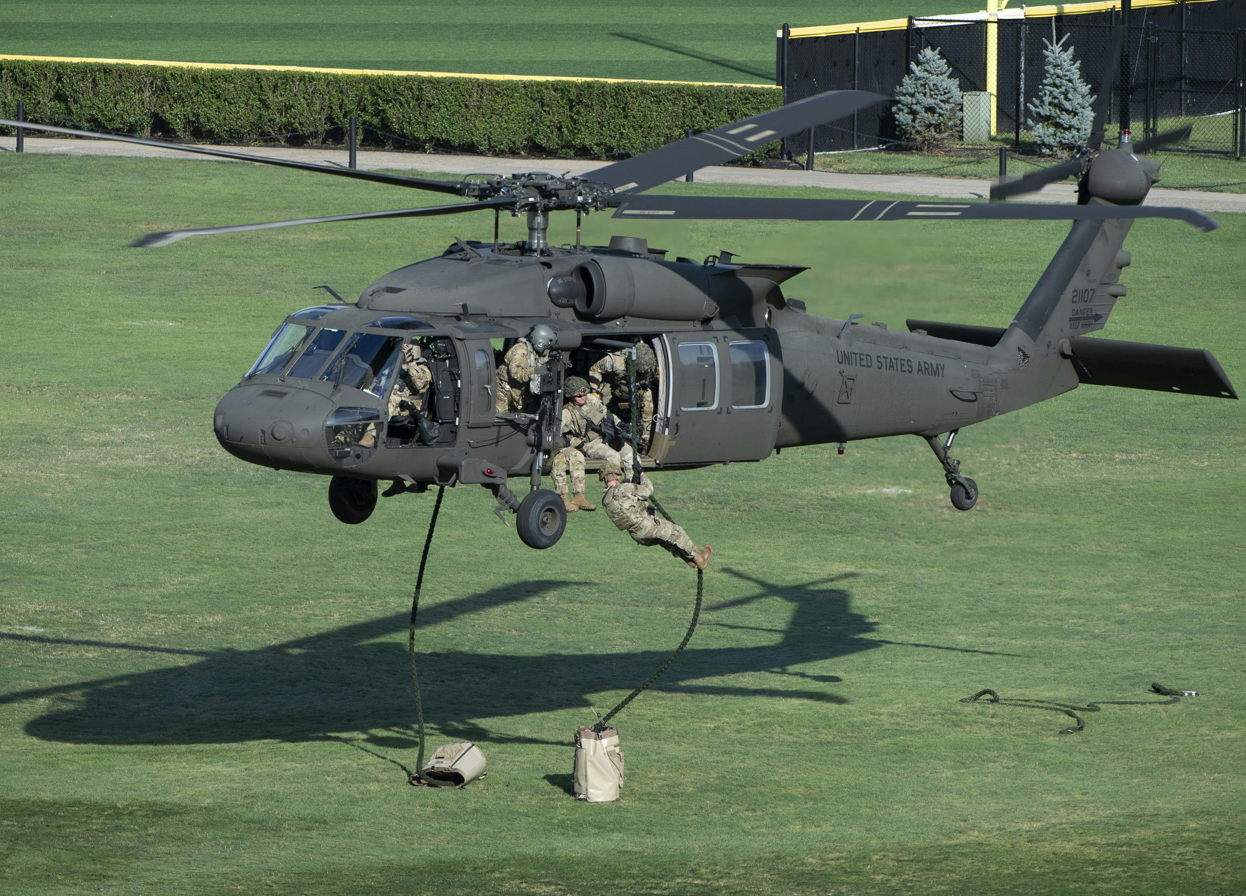 A New York Army National Guard UH-60M Black Hawk helicopter hovers at the United States Military Academy at West Point last August as Soldiers from the 101st Airborne Division (Air Assault) fast-rope down to the ground during a capabilities demonstration for cadets.